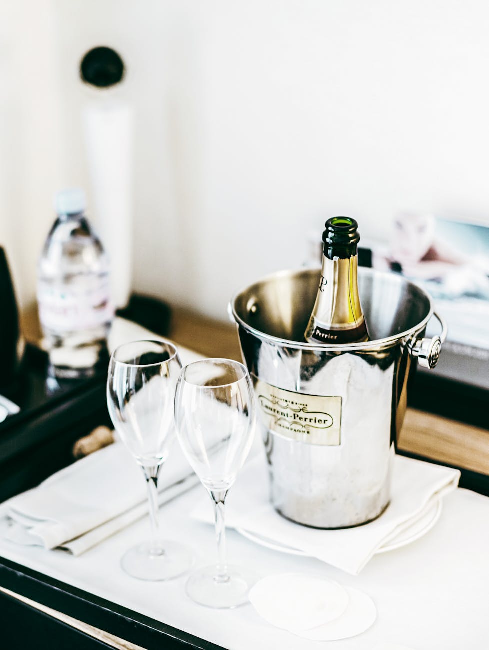 a champagne bottle in an ice bucket. Photo by Victoria on Pexels.com